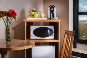 a microwave sitting on a shelf next to a table at Staypineapple, University Inn, University District Seattle in Seattle