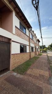 an empty street in front of a building at Pousada Akros in Asunción