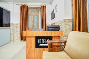 a hotel room with a desk and a chair at Hotel O Jankipuram Vikas Nagar in Lucknow