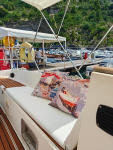 a boat with two pillows sitting on the deck at Dormire in Barca a Vela in Maratea
