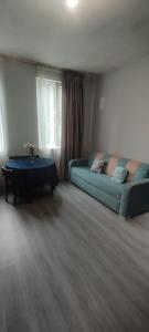 a living room with a couch and a table at House Gio - Birdwatching in Sakhalvasho