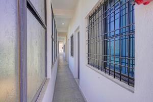 an empty hallway with windows in a building at Collection O Iskcon Aurangabad Formerly Everest Inn in Chikalthān