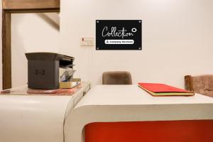 a table in a room with a sign on the wall at Collection O Gol Park Atala in Prayagraj