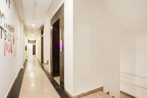 a corridor in a building with white walls and a hallway at Collection O Gol Park Atala in Prayagraj
