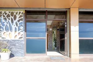 an entrance to a building with a glass door at Hotel O Uttaranchal University Dehradun in Jhājra