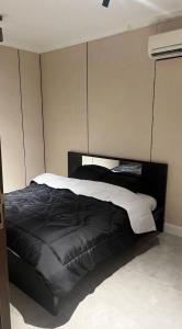 a bedroom with a black bed in a room at darnas in Jeddah