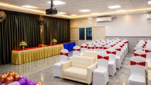 a room with rows of chairs and tables with hearts at Hotel Takasi Heaven in Anakāpalle