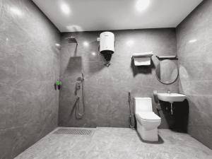 a bathroom with a shower and a toilet and a sink at Hotel Takasi Heaven in Anakāpalle