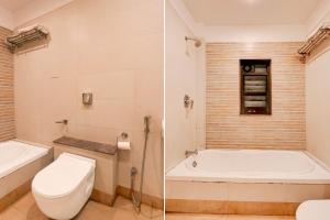 a bathroom with a toilet and a bath tub at Townhouse Oak Ramdaspeth Downtown in Nagpur