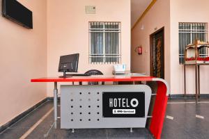 a red table with a hotel sign on top of it at Hotel O AIIMS Raipur in Raipur