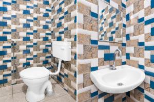 a bathroom with a toilet and a sink at Super Hotel O Temple Road Vemulavada in Karīmnagar