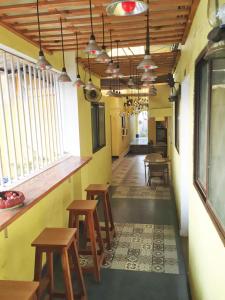 a room with benches and tables in a restaurant at The Mamta Courtyard Anjuna in Anjuna