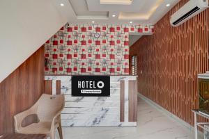 a lobby with a hotel sign on a wall at Super Hotel O by OYO ISBT Mohali Formerly Holiday Spot in Mohali