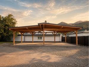 a large wooden pavilion in front of a building at Bergblick Zimmervermietung in Ebensee