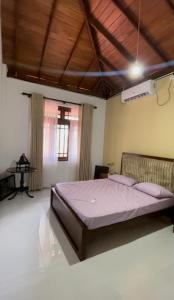 a bedroom with a large bed in a room at Rest Harrow Estate in Kandy