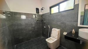 a bathroom with a toilet and a sink at Elevara Eco Resort - Wasgamuwa in Kathurupitiya