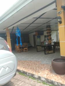 a car parked in a garage with a blue kite at Gemini Hotel & Restaurant in Libaong