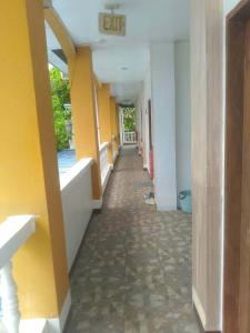 an empty hallway of a building with yellow walls at Gemini Hotel & Restaurant in Libaong