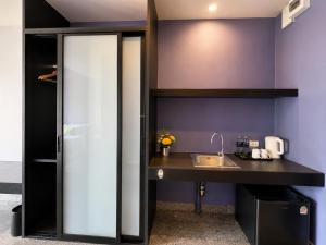 a kitchen with a sink and a counter at iCheck inn Phuket Town in Phuket