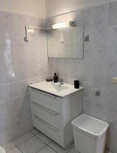 a bathroom with a sink and a mirror and a toilet at Fare Havai - Raiatea in Taputapuapea +20 photos