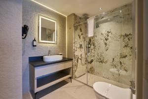 a bathroom with a sink and a shower at Ramses Hotel İzmir in İzmir +37 photos