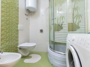 a bathroom with a toilet sink and a washing machine at Vacation home Marin in Vinišće +28 photos