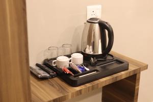 a coffee maker on a shelf in a hotel room at Grand Heritage in Ernakulam