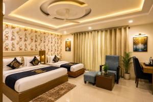 a hotel room with two beds and a desk at HOTEL D'CAPITOL - DELHI AiRPORT in New Delhi +107 photos