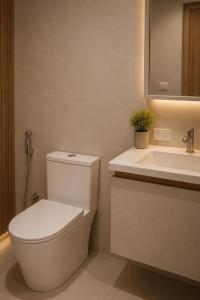 a bathroom with a toilet and a sink at Casa Andrea Bukidnon in Impasugong +28 photos