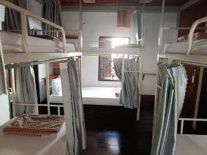 a group of bunk beds in a room at City Backpackers Hostel in Luang Prabang +3 photos