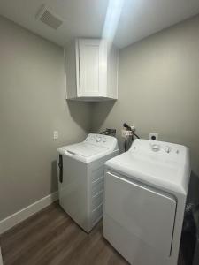 a laundry room with a washer and a sink at Only minutes away from Surfside Beach in Freeport
