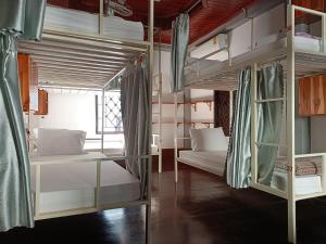 a room with two bunk beds and a window at City Backpackers Hostel in Luang Prabang