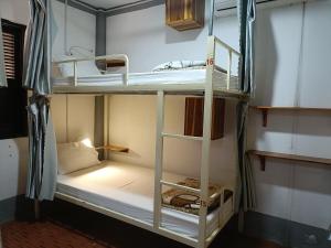 a room with two bunk beds in a room at City Backpackers Hostel in Luang Prabang