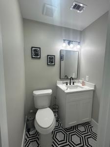 a bathroom with a toilet and a sink and a mirror at Only minutes away from Surfside Beach in Freeport +3 photos