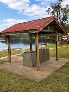 a gazebo with a picnic table in a park at Garden Studio with Private Patio in Wentworth Falls +10 photos