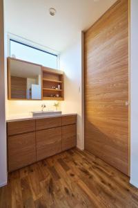 a bathroom with a sink and a wooden door at Ｔｉｌｔ - Vacation STAY 16720 in Karatsu +16 photos