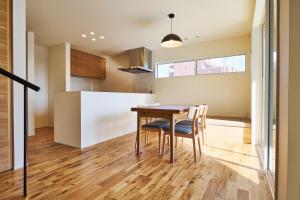 a kitchen and dining room with a wooden table and chairs at Ｔｉｌｔ - Vacation STAY 16720 in Karatsu
