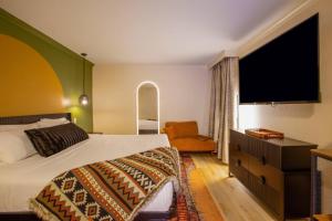 a bedroom with a bed and a flat screen tv at Arroyo Pinion Hotel, an Ascend Collection Hotel in Sedona