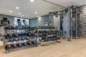 a gym with a bunch of equipment in a room at Cambria Hotel West Orange in West Orange
