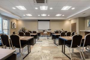 a conference room with tables and chairs and a whiteboard at Cambria Hotel West Orange in West Orange +81 photos