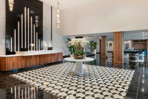 a lobby with a table with flowers on it at Cambria Hotel Detroit Downtown in Detroit
