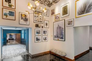 a hallway with pictures on the wall and chairs at Cambria Hotel Detroit Downtown in Detroit +84 photos