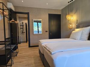 a bedroom with a large bed and a bathroom at Drau Lodge in Wernberg +40 photos