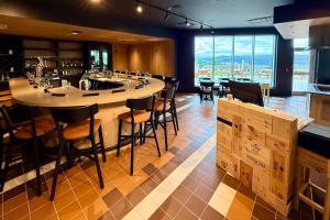 a bar in a restaurant with a counter and chairs at Quality Inn & Suites Temiscouata-sur-le-Lac in Notre-Dame-du-Lac