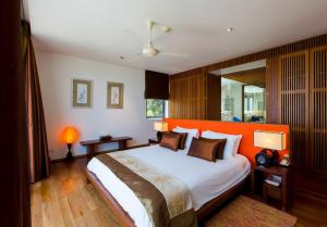 a bedroom with a large bed with an orange headboard at The heights luxury sea view 2BR near Kata Beach in Kata Beach +30 photos