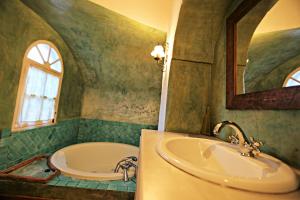a bathroom with a tub and a sink and a bath tub at El Rincón de San Benito in Cazalla de la Sierra +14 photos