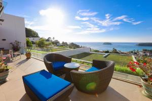 a patio with chairs and tables and a view of the ocean at The heights luxury sea view 2BR near Kata Beach in Kata Beach