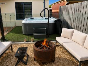 a backyard with a fire pit and a hot tub at Solander in Dromana with Private Spa by Ready Set Stay in Dromana