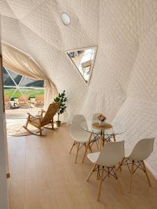 a room with a table and chairs and a window at Kupolica glamping dome in Brčko