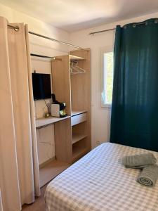 a small bedroom with a bed and a window at Le Clos d'AIX studio 305 in Aix-en-Provence